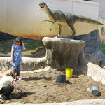children scoop away sand in our paleontological dig